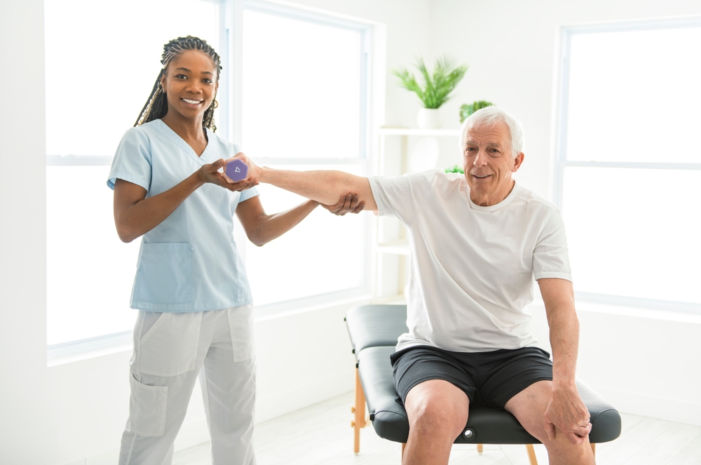 A man seeing a doctor for his shoulder pain.