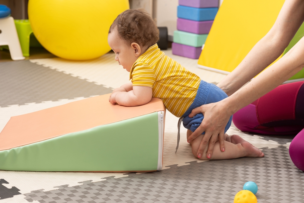 An infant physical therapy session with a specialist.