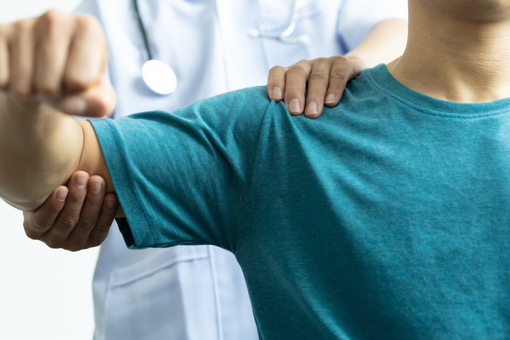 Someone experiencing shooting shoulder pain. 