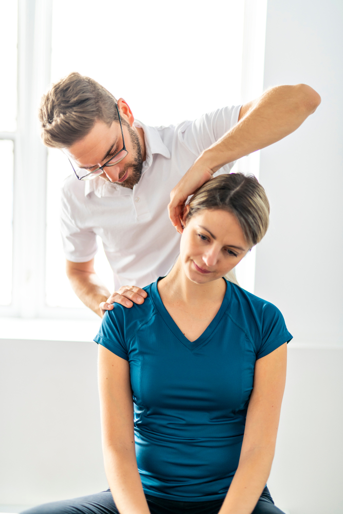 A doctor helping perform physical therapy techniques for neck pain
