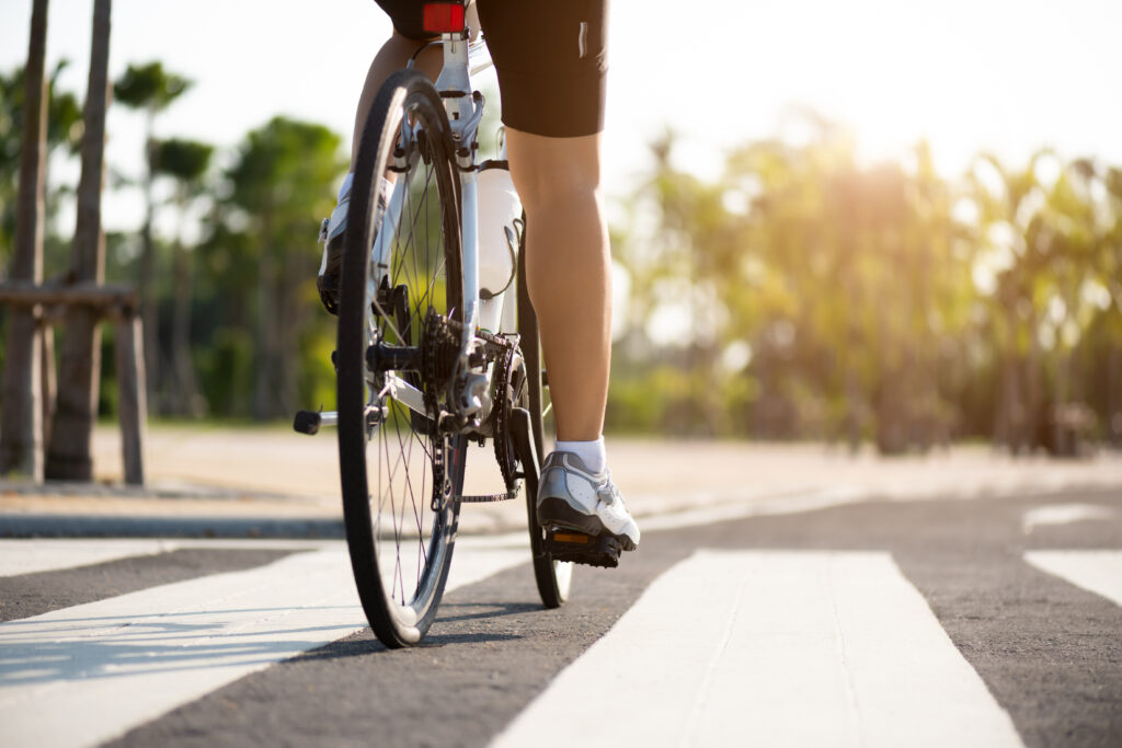 lower half of a biker riding on pavement