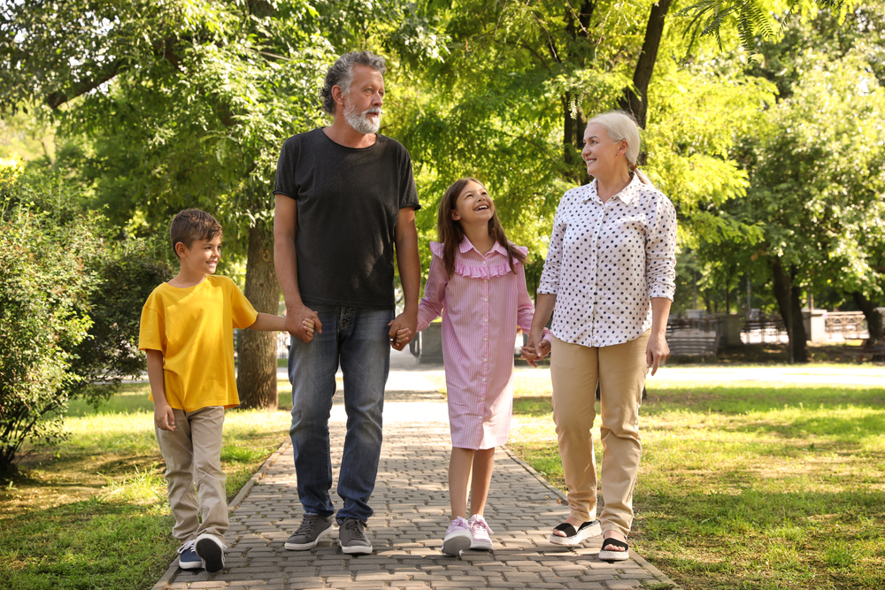 the same man takes a walk with his wife and grandchildren,  he hopes to gain relief from knee repair without surgery by exercising 