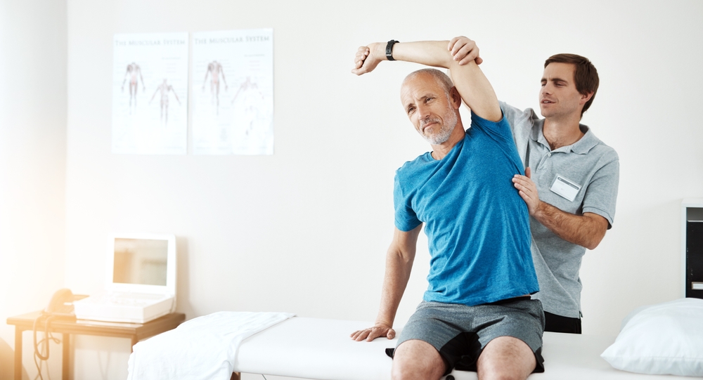 Physical therapist showing patient tips and exercises to improve joint health