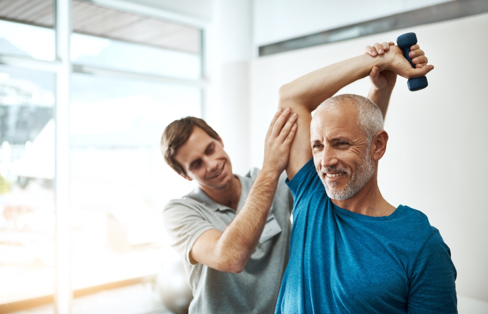 physical therapist providing manual therapy with light weights to improve joint health