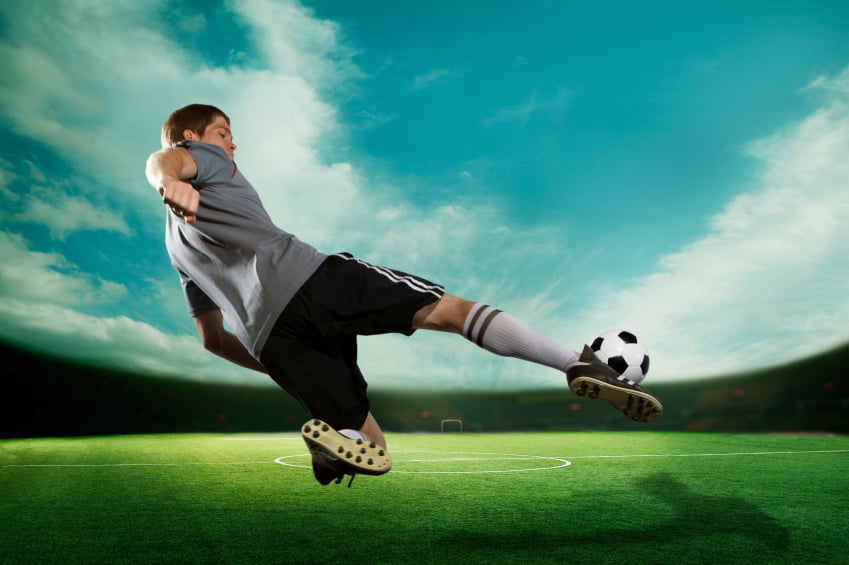 man kicking a ball during physical therapy for athletes
